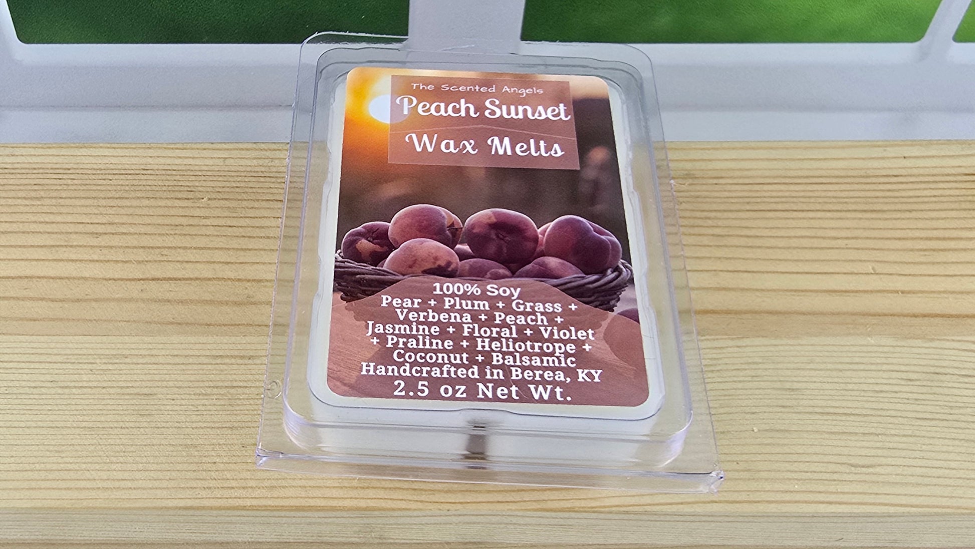 Peach Sunset Wax Melts packaging on a wooden surface