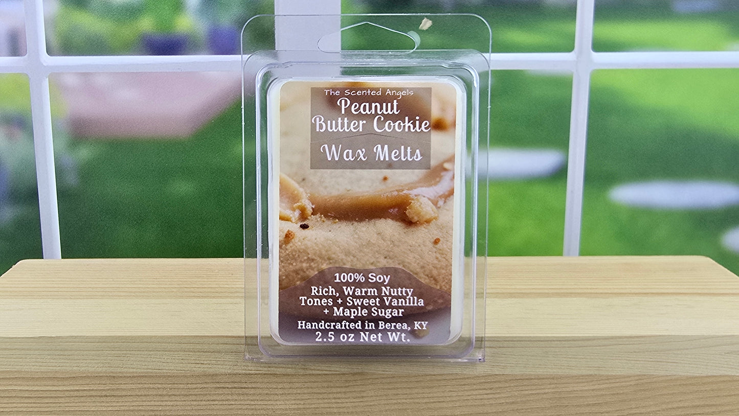 Peanut Butter Cookie wax melt packaging on a wooden surface with a blurred outdoor background
