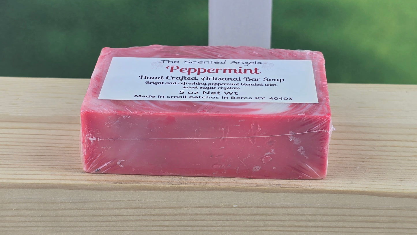 Bottom view of Peppermint bar of soap with a label on a wooden surface