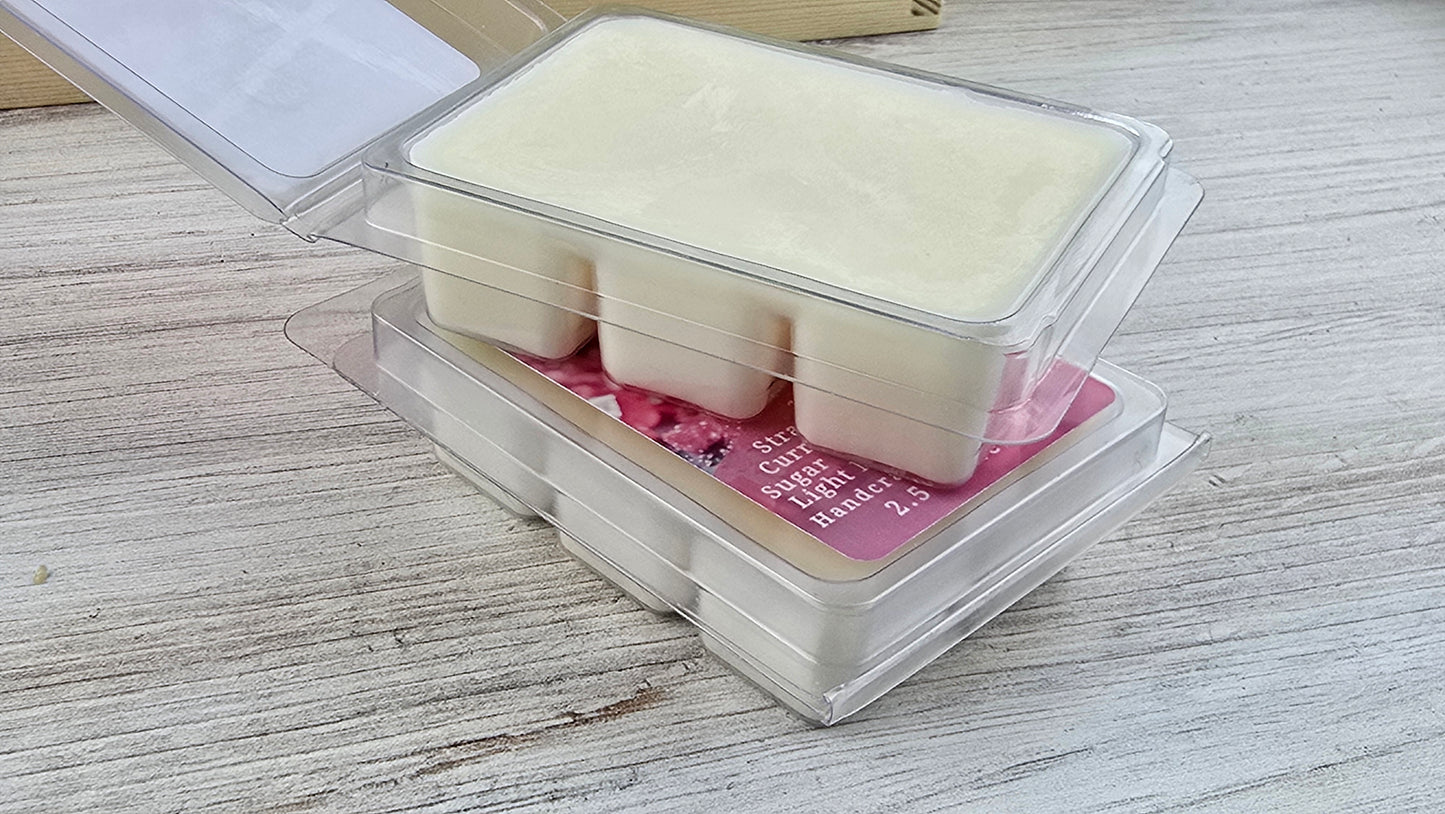 Packaged wax melts with a pink label on a wooden surface