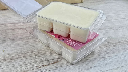 Packaged wax melts with a pink label on a wooden surface