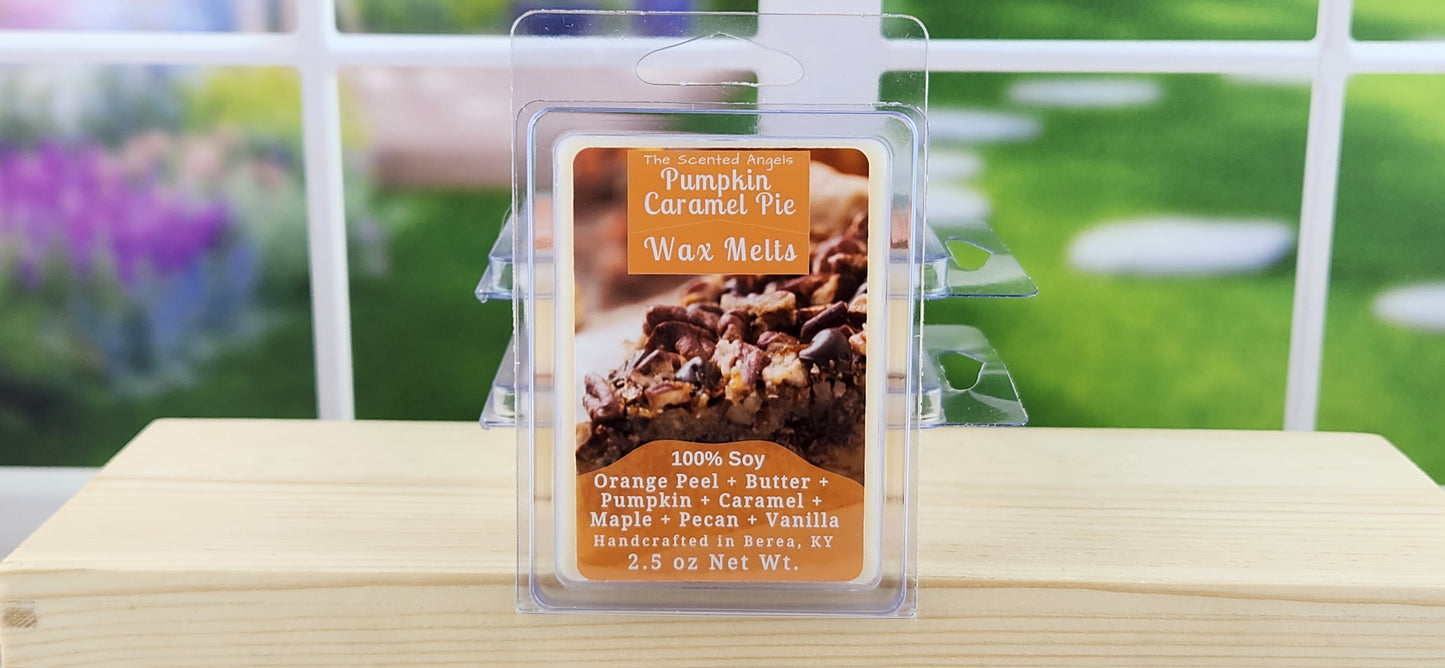 Pumpkin caramel pie wax melt packaging on a wooden surface with a blurred outdoor background