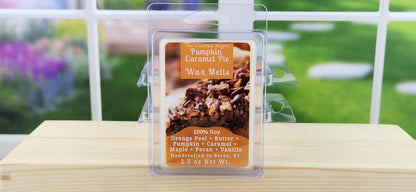 Pumpkin caramel pie wax melt packaging on a wooden surface with a blurred outdoor background