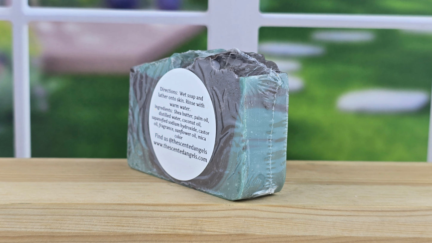 Bar of soap with a label on a wooden surface, outdoor background
