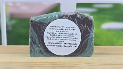 Bar of soap with a label on a wooden surface, outdoor background