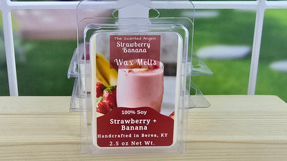 Strawberry Banana wax melt packaging on a wooden surface with a blurred outdoor background