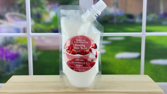 A pouch of Handmade Sugared Strawberries 100% Soy Squeezy Wax Melts displayed in front of a blurred background.
