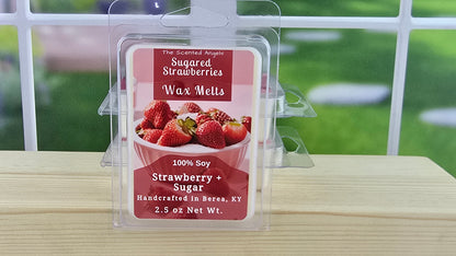 Packaged wax melts with strawberry and sugar flavor on a wooden surface.