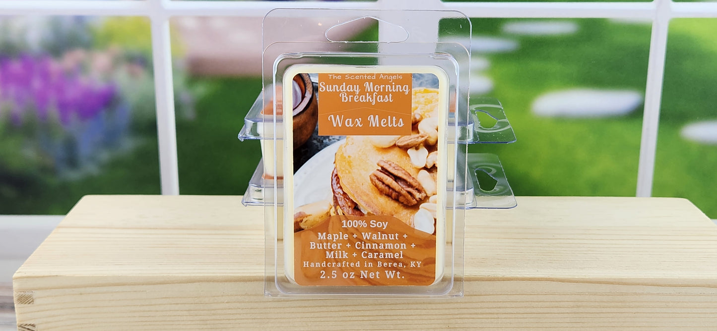 Wax melt packaging with a 'Sunday Morning Breakfast' label on a wooden surface with a blurred outdoor background.