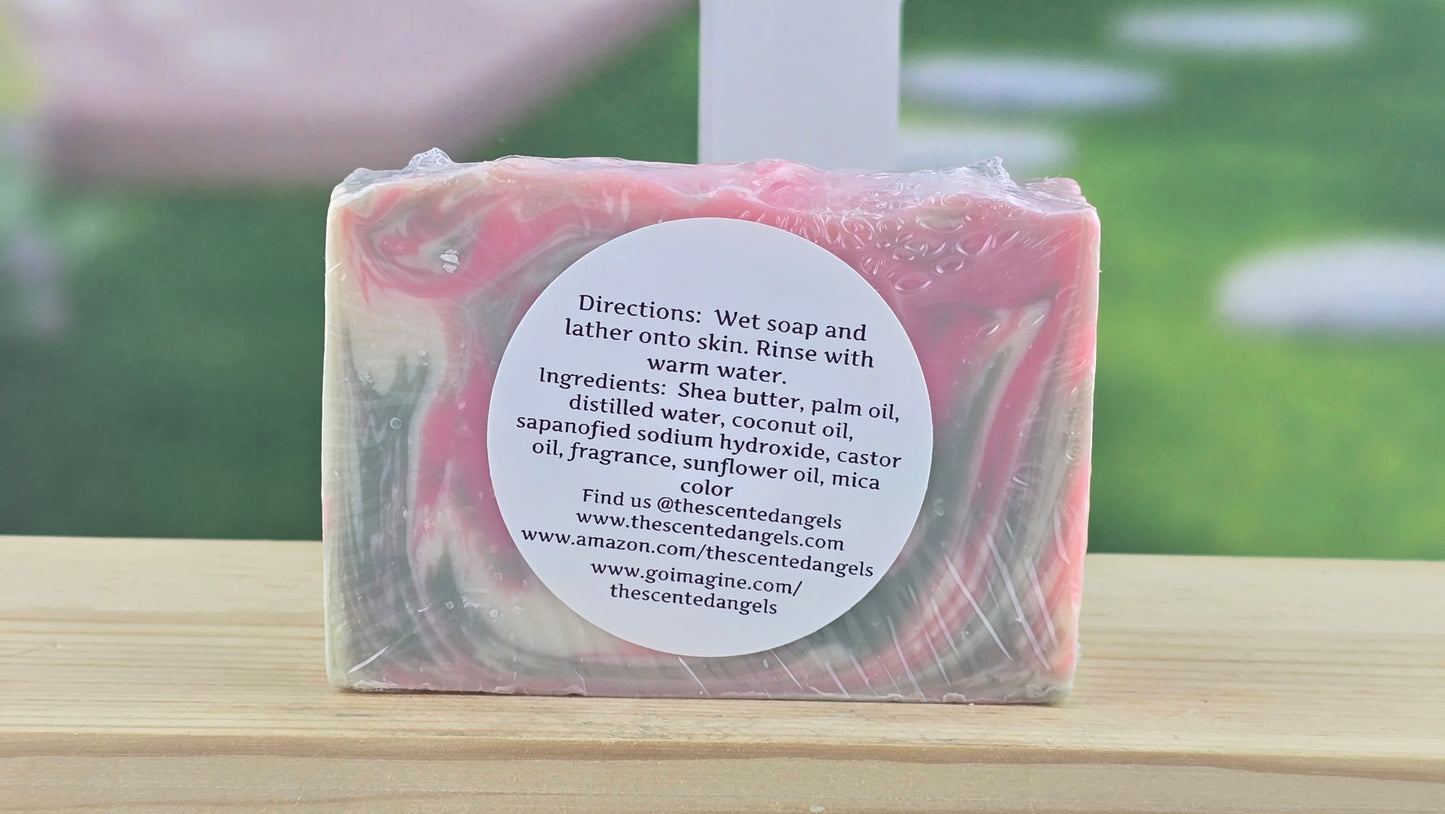 Bar of soap with a label on a wooden surface, blurred green outdoor background