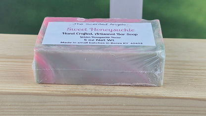 Bar of soap with a label on a wooden surface