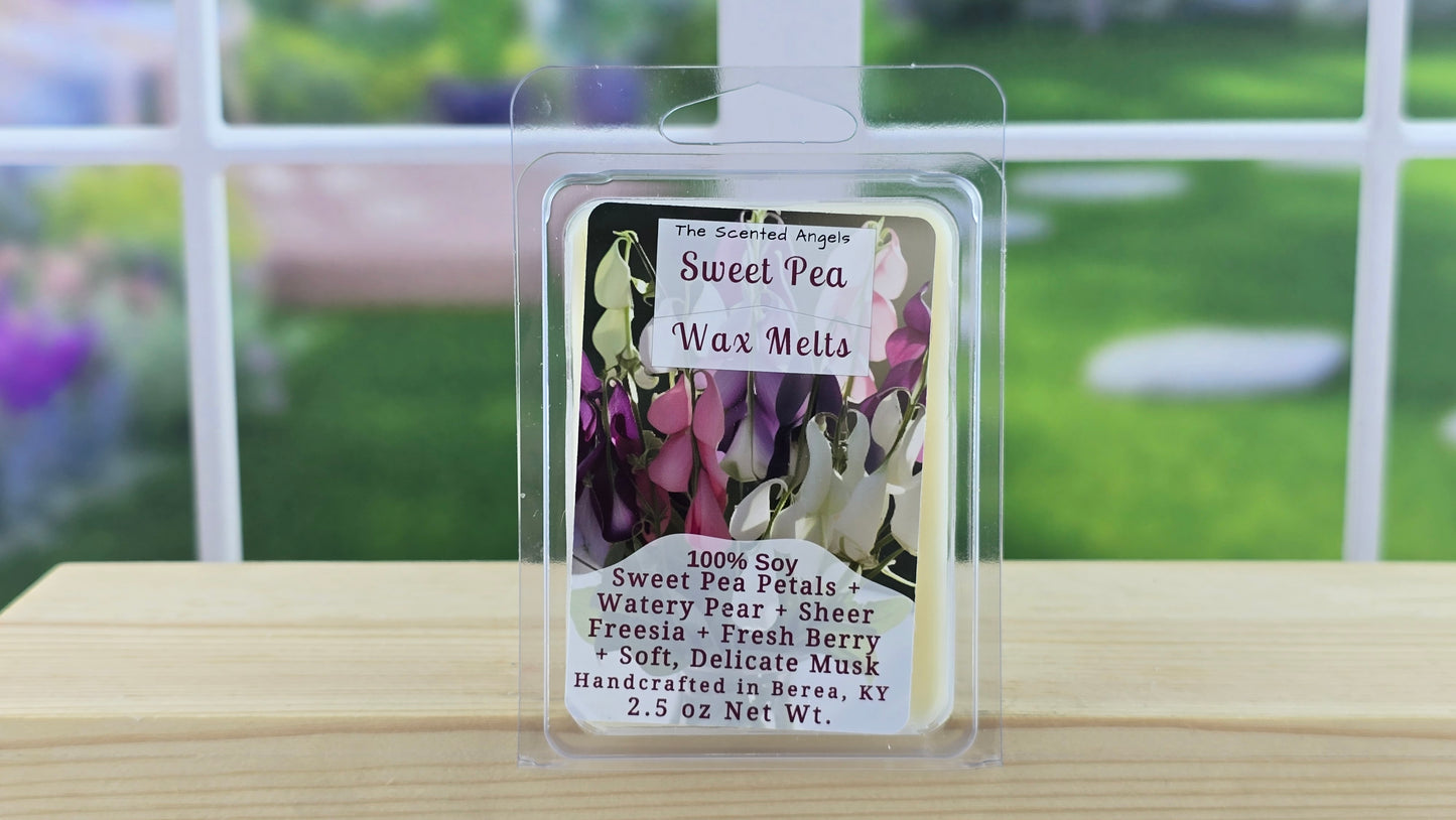 Sweet Pea wax melts packaging on a wooden surface with a blurred outdoor background
