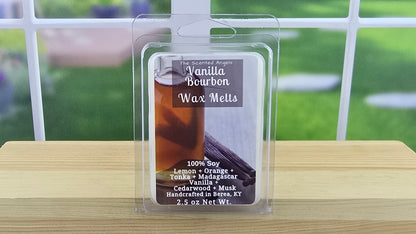 Packaged Vanilla Bourbon wax melts on a wooden surface with a blurred outdoor background