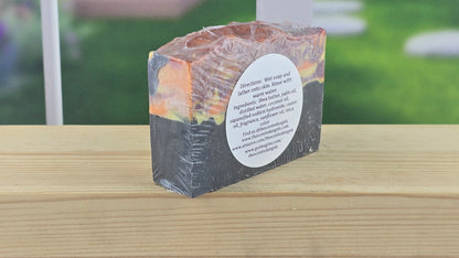 Bar of soap with a label on a wooden surface