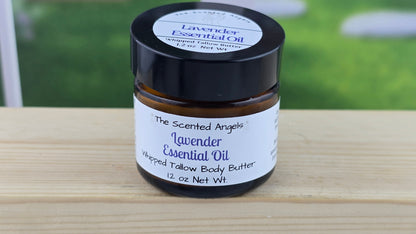 Jar of lavender essential oil whipped tallow body butter on a wooden surface.