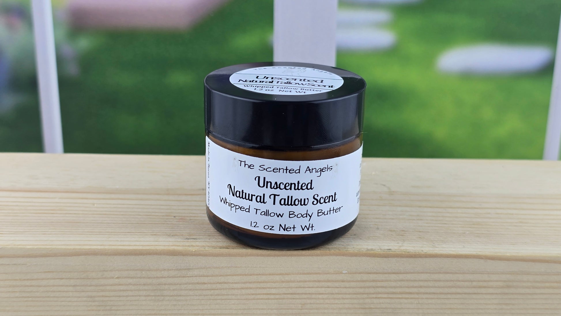 Natural tallow scent body butter on a wooden surface