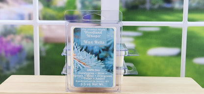 Woodland Whisper wax melt packaging on a table with a blurred outdoor background